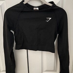 A black Gymshark Crop Top in size M with thumb holes.